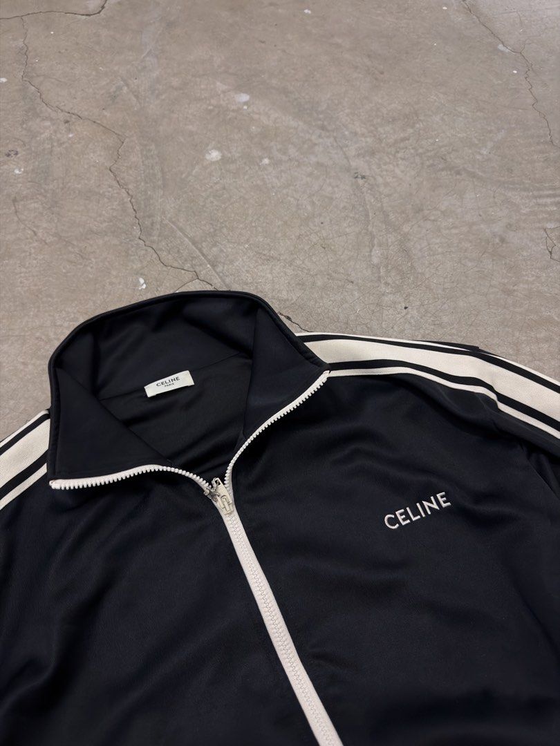 Celine Black Track Jacket (Category: Coats, Jackets and Outerwear) located in Alfonso. Submitted by jbcamet (Listing ID 1463068147, Image 2). Description: - Classic black Celine track jacket - White stripe detailing on sleeves and collar - Full zip front with branded zipper pull - Two side pockets - Size L - Ideal for casual wear or athleisure.