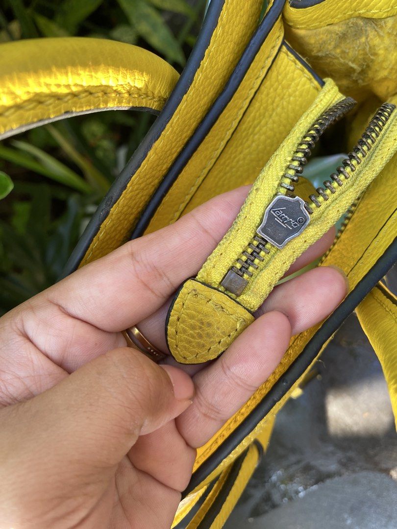 Celine micro Luggage Tote Yellow Leather (Category: Luxury Bags & Wallets) located in Manila. Submitted by cdb_22 (Listing ID 1463111821, Image 3). Description: - Yellow Celine Nano Luggage tote - Made from textured leather - Front zip pocket - Top handles - Interior zip pocket - Celine Paris logo stamped inside - Celine logo on zipper pull - Ideal size for everyday essentials.
