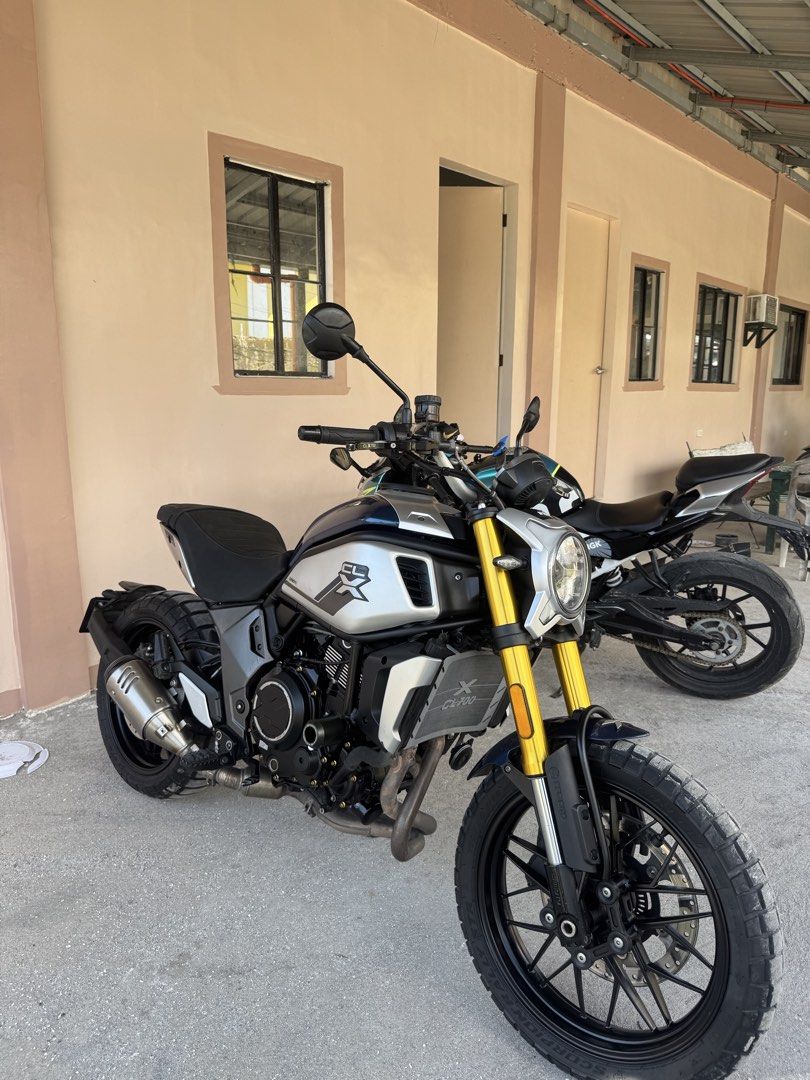 CFMoto 700CL-X Heritage Motorcycle (Category: Motorbikes for Sale) located in Pasig City. Submitted by acombalecer (Listing ID 1462932306, Image 2). Description: CFMoto 700CL-X Heritage. Scrambler style motorcycle. Dark blue and silver colorway. Gold front forks. Black wheels and exhaust. Ready for your next ride. 2021 CLX700 31k odo Buletproof engine Alaga ung bike kita naman Newly Heavy Pms @26k odo New Sprocket New Chain New Tires Pirelli STR 