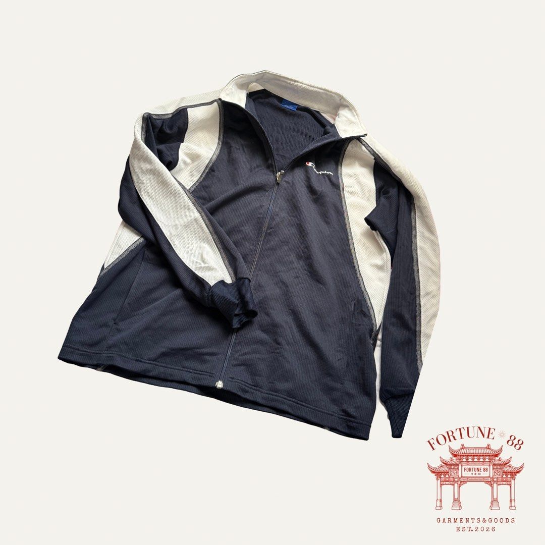 Champion Navy & White Full-Zip Track Jacket (Category: Coats, Jackets and Outerwear) located in Paranaque City. Submitted by f0rtune_88 (Listing ID 1462901881, Image 2). Description: Size: L Measurements: Shoulder 19” | Chest 23” | Length 27” | Sleeve 23” Color: Navy Blue / White Material: Cotton Mesh Style: Vintage Sportswear / Track Jacket Fit: Relaxed Fit Details: Full-zip front, contrast white panels, embroidered Champion chest logo, side poc