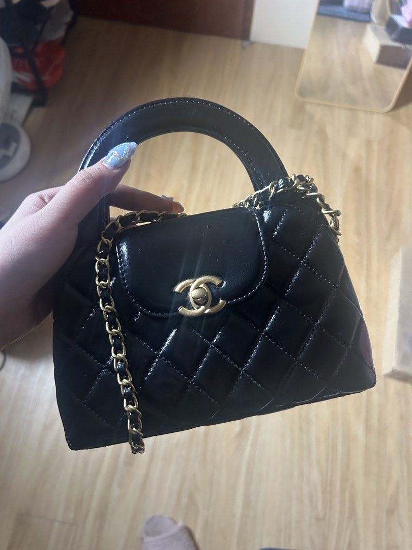 Chanel mini handbag black (Category: Luxury Bags & Wallets) located in Cavite. Submitted by zacharyyy__ (Listing ID 1462968503, Image 2). Description: - Black patent leather handbag - Quilted design - Gold CC logo clasp - Top handle - Detachable gold chain strap - Chic and classic style - Versatile for dressing up or down - Fits essentials - no issues - can ask for more photos for sure buyer - with chain 2k only 📍gma cavite Can lalamove around n