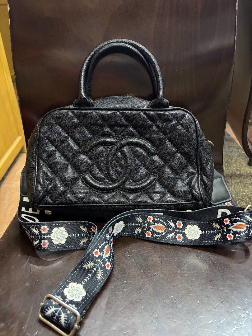 Chanel Quilted Black Leather Top Handle Bag with Strap (Category: Luxury Bags & Wallets) located in Manila. Submitted by robbyrabbit (Listing ID 1462919805, Image 1). Description: - Black quilted leather handbag - Iconic CC logo on the front - Decorative strap included - Secure zipper closure - Interior serial number plate - Versatile for daily use or special events.