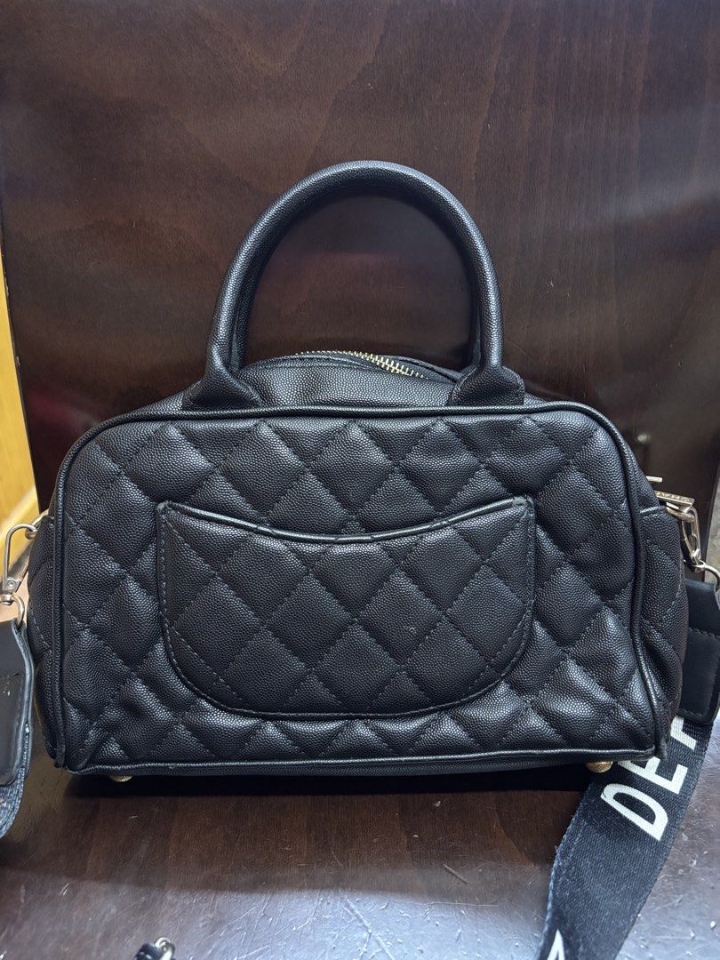 Chanel Quilted Black Leather Top Handle Bag with Strap (Category: Luxury Bags & Wallets) located in Manila. Submitted by robbyrabbit (Listing ID 1462919805, Image 3). Description: - Black quilted leather handbag - Iconic CC logo on the front - Decorative strap included - Secure zipper closure - Interior serial number plate - Versatile for daily use or special events.