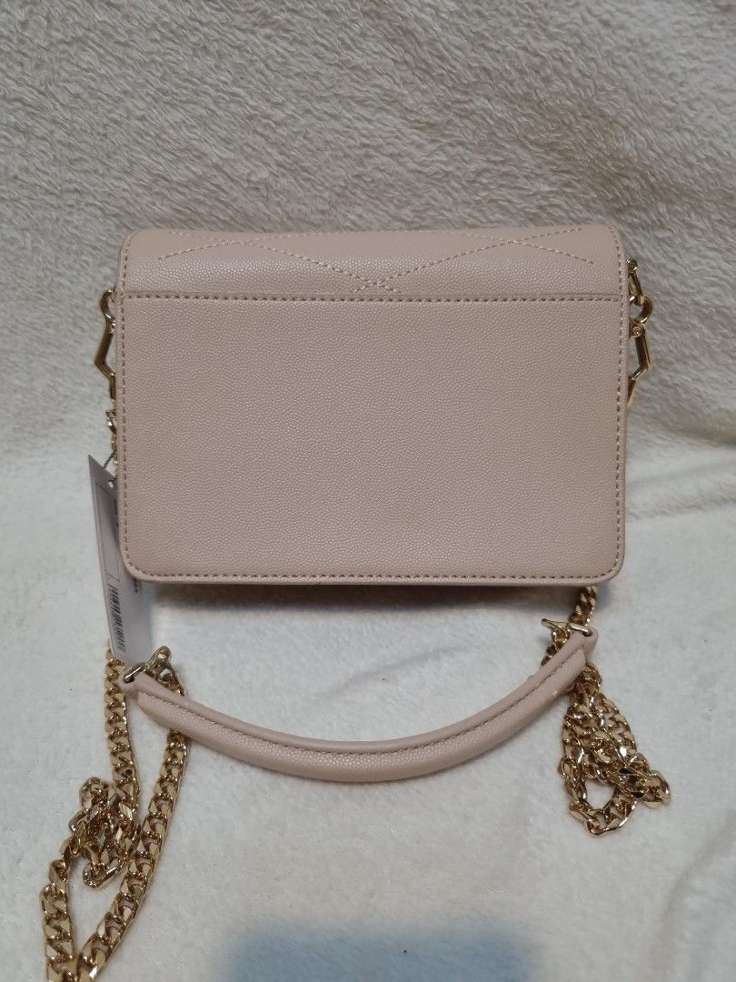 Charles & Keith Beige Quilted Chain Shoulder Bag (Category: Shoulder Bags) located in Caloocan City. Submitted by scar678910-26073 (Listing ID 1463073274, Image 2). Description: - Beige quilted shoulder bag by Charles & Keith - Elegant gold chain strap - Interior zip pocket for essentials - Multiple card slots for organization - Comes with original tag - Versatile for both everyday wear and evening events.