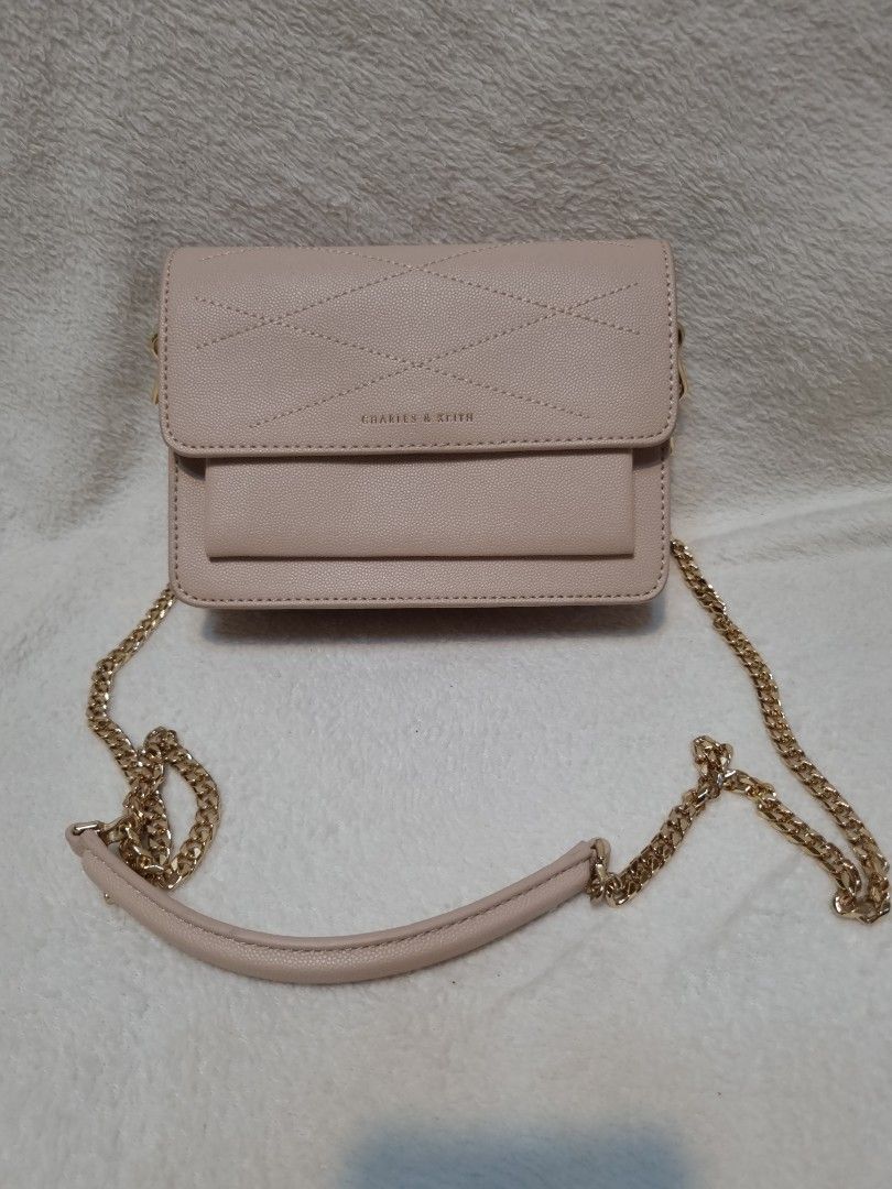 Charles & Keith Beige Quilted Chain Shoulder Bag (Category: Shoulder Bags) located in Caloocan City. Submitted by scar678910-26073 (Listing ID 1463073274, Image 1). Description: - Beige quilted shoulder bag by Charles & Keith - Elegant gold chain strap - Interior zip pocket for essentials - Multiple card slots for organization - Comes with original tag - Versatile for both everyday wear and evening events.