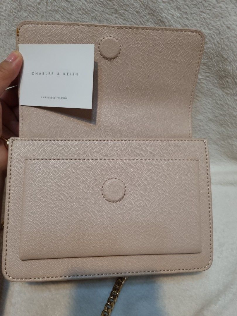 Charles & Keith Beige Quilted Chain Shoulder Bag (Category: Shoulder Bags) located in Caloocan City. Submitted by scar678910-26073 (Listing ID 1463073274, Image 3). Description: - Beige quilted shoulder bag by Charles & Keith - Elegant gold chain strap - Interior zip pocket for essentials - Multiple card slots for organization - Comes with original tag - Versatile for both everyday wear and evening events.