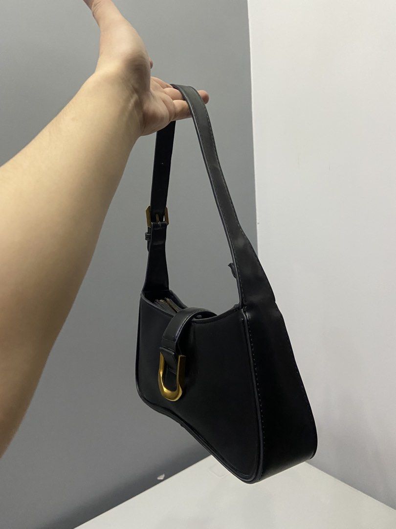 Charles & Keith Black Shoulder Bag with Gold Hardware (Category: Shoulder Bags) located in Cabanatuan. Submitted by kimmyyy12344 (Listing ID 1463047956, Image 3). Description: - Brand: Charles & Keith - Color: Black - Style: Classic Baguette Shoulder Bag - Features: Gold D-ring buckle detail on front flap - Closure: Zipper - Versatile: Ideal for everyday wear or evening outings - Design: Minimalist.