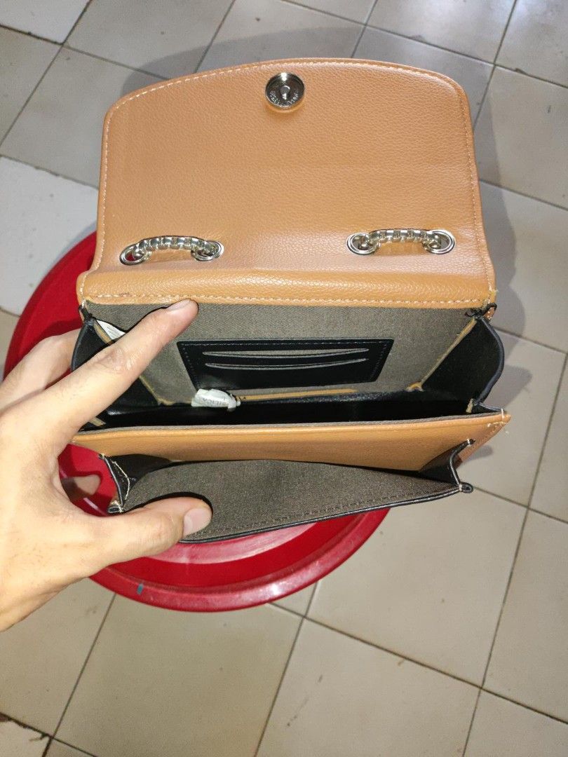 Cheer Rose Small Shoulder / Crossbody Bag (Category: Cross-body Bags) located in Manila. Submitted by warmshark.1ae1ea (Listing ID 1462971885, Image 3). Description: Cheer Rose Small Shoulder / Crossbody Bag – ₱450 Brand: Cheer Rose Brown / tan color Silver-tone chain strap Snap-button closure Front flap pocket Interior compartments Pre-loved condition Minor signs of use, see photos.