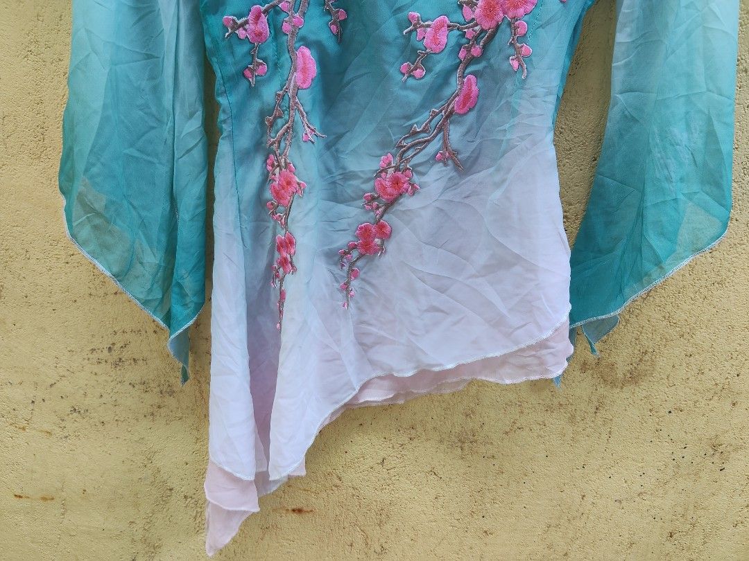 Chinese Style Embroidered Top with Cherry Blossoms (Category: Blouses) located in City of Isabela. Submitted by jasheverything (Listing ID 1462893795, Image 3). Description: - Gradient teal and white color - Intricate pink cherry blossom embroidery on the front - Wide and flowy sleeves - Unique asymmetrical hemline - Versatile for special occasions or stylish everyday looks Excellent Condition Issue Cuttag Small to Med 850+SF.