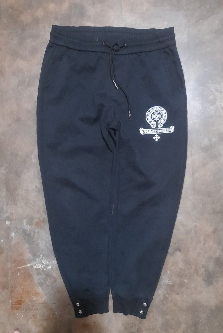 Chrome Hearts Black Joggers Sweatpants (Category: Joggers) located in Taguig. Submitted by sebas_tian (Listing ID 1463030304, Image 2). Description: - Brand: Chrome Hearts (OFF only) - Color: Black - Design: Iconic cross logo on front and back - Features: Elastic waistband with drawstring, ribbed cuffs with button details - Style: Comfortable and stylish for everyday wear.