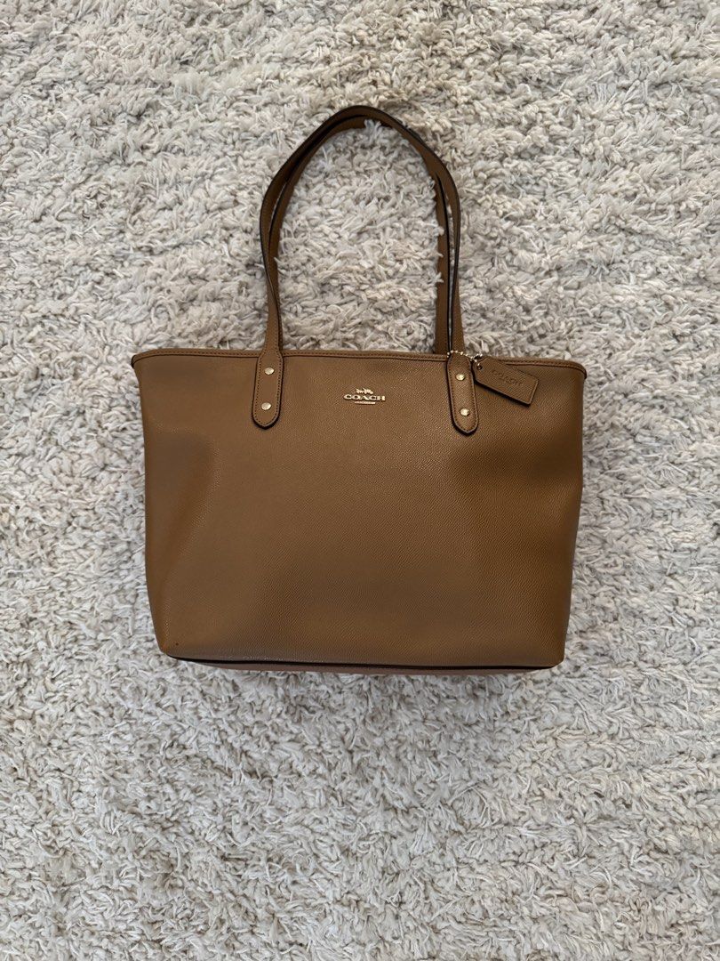 Coach City Zip Tote Bag (Category: Luxury Bags & Wallets) located in San Nicolas. Submitted by ihascat (Listing ID 1462940025, Image 1). Description: - Authentic - Classic brown Coach tote bag - Pebbled leather exterior - Gold hardware - Top handles for carrying - Spacious interior - Great for everyday use - Includes Coach hangtag.