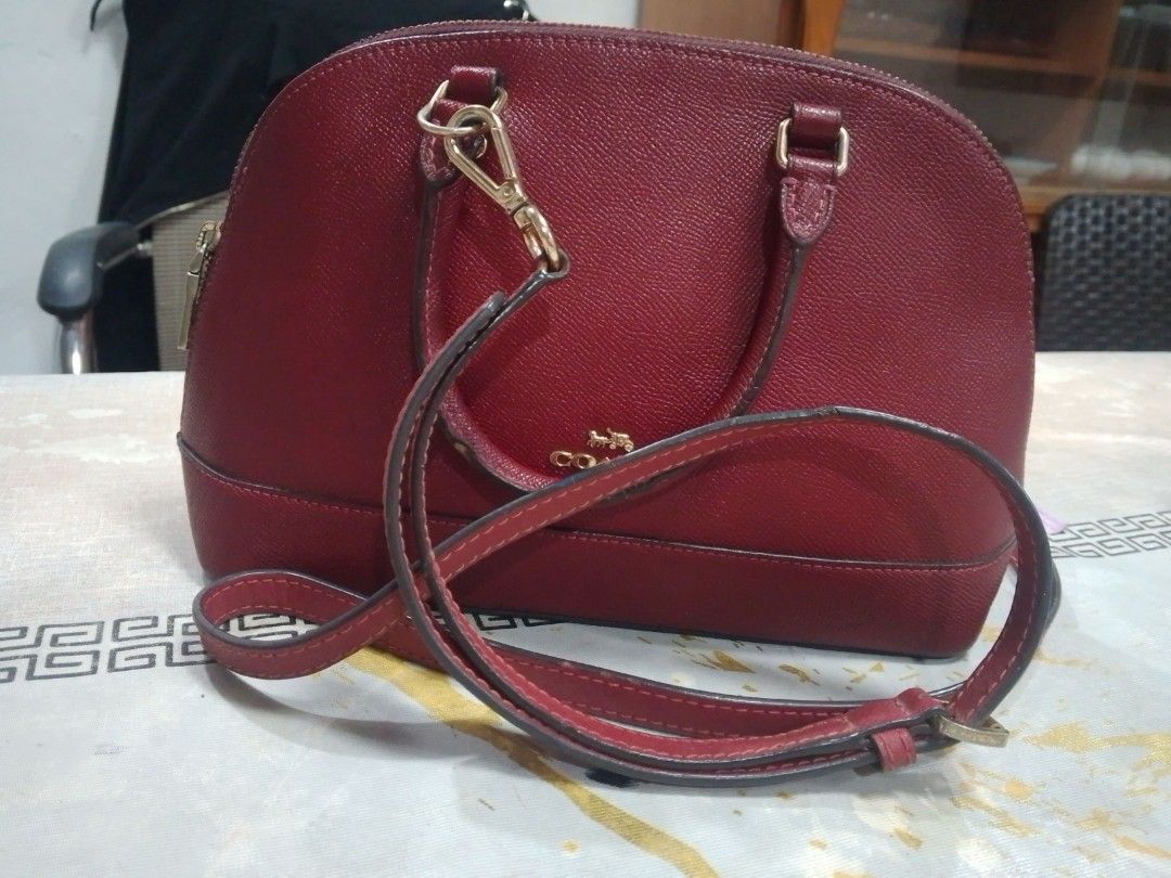 Coach Red Leather Dome Satchel Handbag (Category: Luxury Bags & Wallets) located in Manila. Submitted by annemil_1984 (Listing ID 1462946380, Image 2). Description: - Coach dome satchel in a vibrant red color. - Crafted from genuine leather for a premium feel. - Features comfortable top handles for easy carrying. - Secure zipper closure to keep your belongings safe. - Elegant gold-tone hardware adds a touch of luxury. - Ideal everyday bag with am