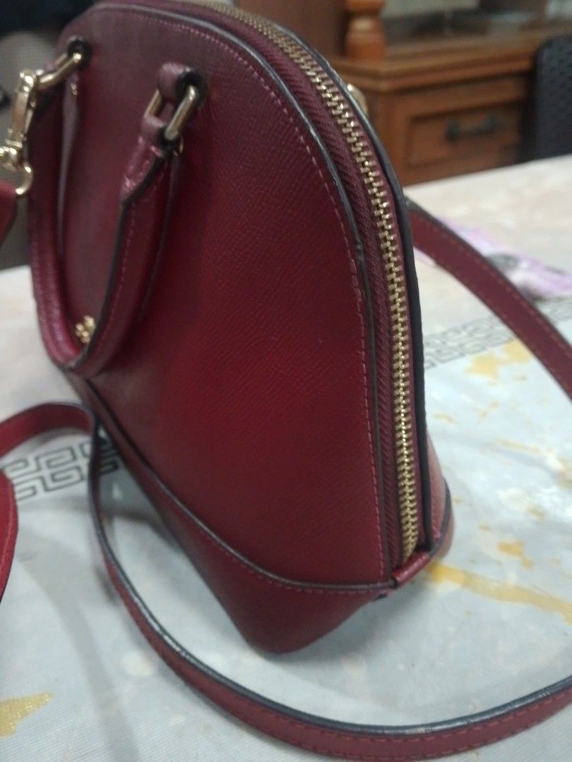 Coach Red Leather Dome Satchel Handbag (Category: Luxury Bags & Wallets) located in Manila. Submitted by annemil_1984 (Listing ID 1462946380, Image 3). Description: - Coach dome satchel in a vibrant red color. - Crafted from genuine leather for a premium feel. - Features comfortable top handles for easy carrying. - Secure zipper closure to keep your belongings safe. - Elegant gold-tone hardware adds a touch of luxury. - Ideal everyday bag with am