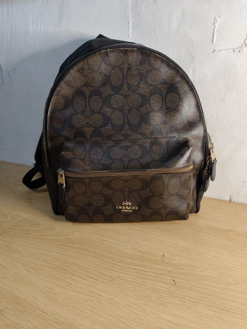 Coach Signature Monogram Backpack Brown Black (Category: Backpacks) located in Cebu City. Submitted by danilobata87944 (Listing ID 1462982026, Image 1). Description: - Authentic Coach backpack in signature brown and black monogram print. - Features a convenient front zip pocket with the Coach logo. - Stylish gold hardware zippers. - Adjustable straps for a comfortable fit. - Ideal for everyday use or travel adventures..