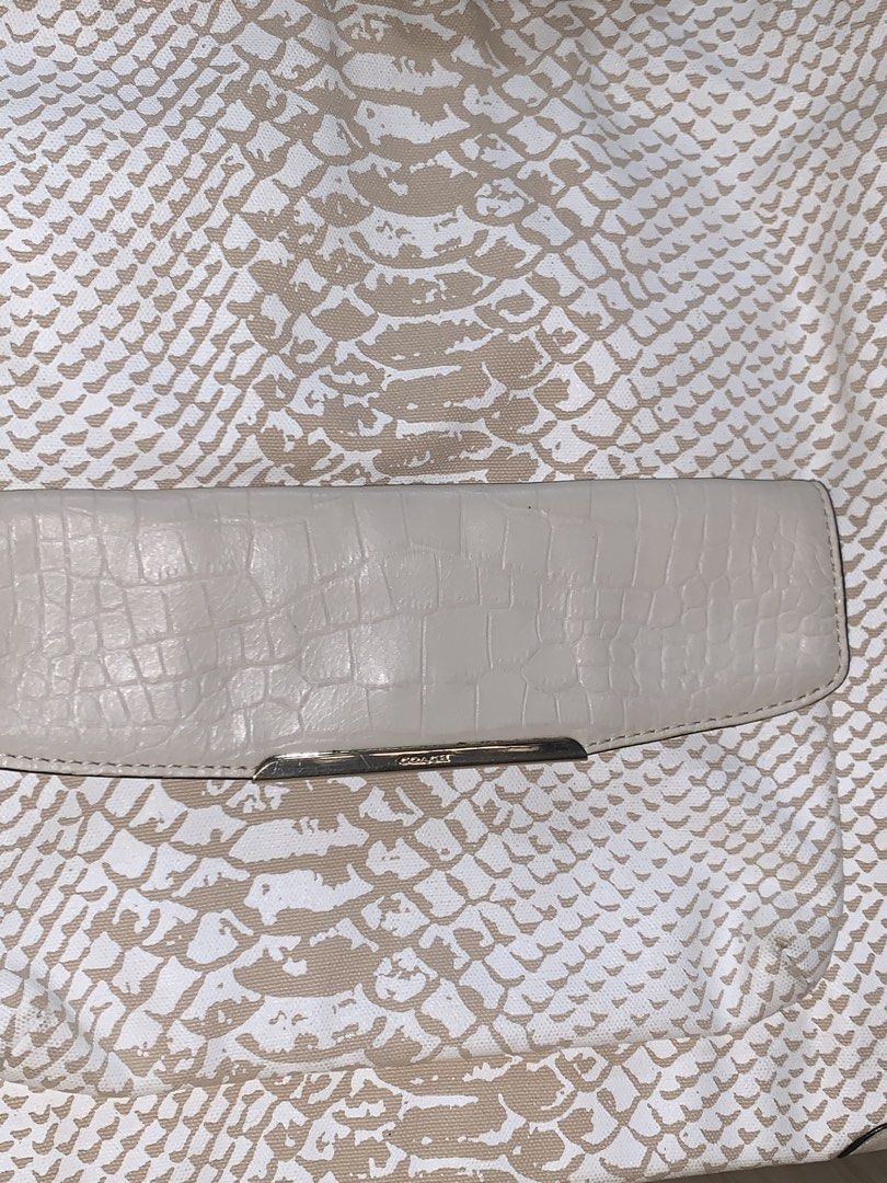 Coach Snakeskin Embossed Leather Shoulder Bag (Category: Luxury Bags & Wallets) located in Manila. Submitted by jo.arban (Listing ID 1462897870, Image 2). Description: - Stylish white and tan snakeskin embossed leather shoulder bag. - Front pocket with a sophisticated croc-embossed flap. - Elegant silver hardware details throughout. - Comfortable adjustable shoulder strap for a custom fit. - Ample interior space for all your essentials. - Your pe