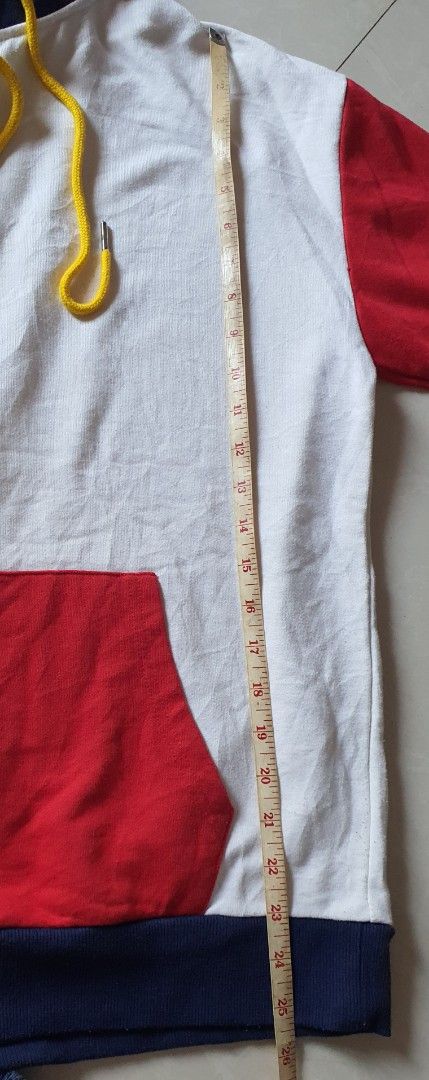 Colorblock Hoodie with Drawstrings (Category: Hoodies) located in Meycauayan. Submitted by shoptoown (Listing ID 1462941038, Image 3). Description: - White hoodie with vibrant red, blue, and yellow colorblock details on sleeves. - Features a convenient front pocket for essentials. - Adjustable yellow drawstrings for a customized fit. - Approximate measurements: Length 26 inches, Width 24 inches. - Note: Small stain on the back, washable, clearly 