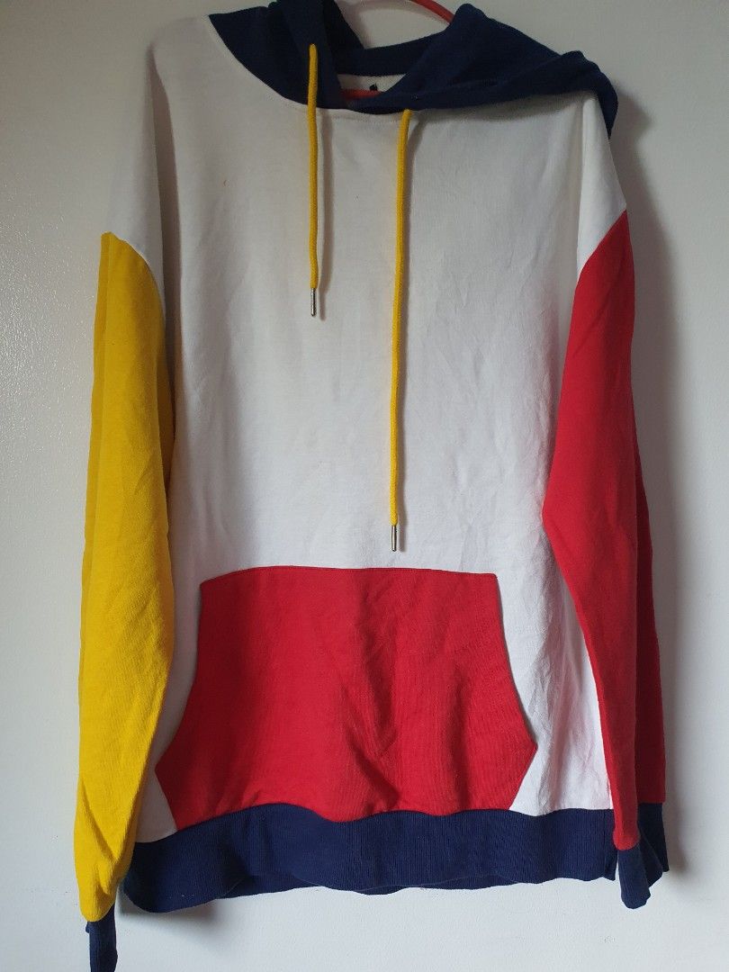 Colorblock Hoodie with Drawstrings (Category: Hoodies) located in Meycauayan. Submitted by shoptoown (Listing ID 1462941038, Image 1). Description: - White hoodie with vibrant red, blue, and yellow colorblock details on sleeves. - Features a convenient front pocket for essentials. - Adjustable yellow drawstrings for a customized fit. - Approximate measurements: Length 26 inches, Width 24 inches. - Note: Small stain on the back, washable, clearly 
