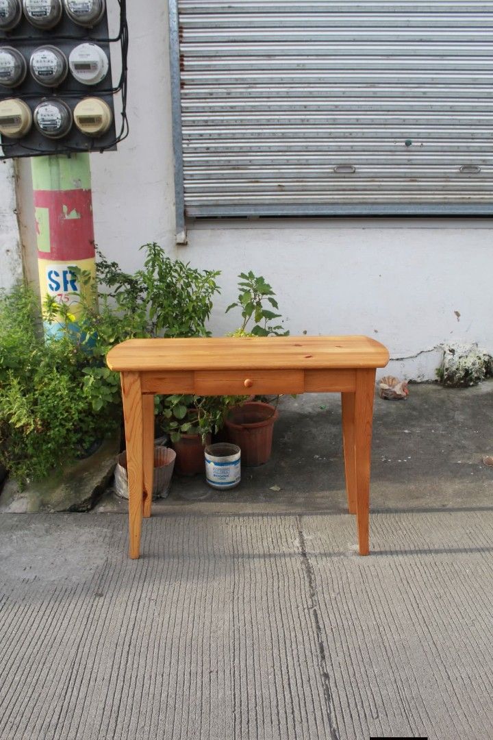 Console table (Category: Tables & Sets) located in Meycauayan. Submitted by marygracecasimiro (Listing ID 1463050607, Image 2). Description: Solid Wood Console Table Vintage solid pine console table with a rustic Shaker-style design, warm honey finish, rounded tabletop ends, a spacious center drawer and tapered wooden legs. Perfect for entryways, living rooms, bedrooms or as a writing desk or vanity table L:39 ¼ • W:15 ¾ • H:29 ½ inches 8,900 pes
