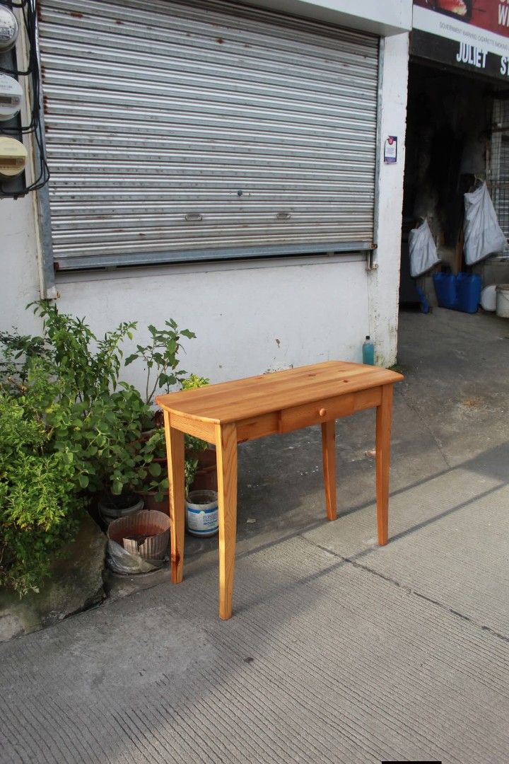 Console table (Category: Tables & Sets) located in Meycauayan. Submitted by marygracecasimiro (Listing ID 1463050607, Image 3). Description: Solid Wood Console Table Vintage solid pine console table with a rustic Shaker-style design, warm honey finish, rounded tabletop ends, a spacious center drawer and tapered wooden legs. Perfect for entryways, living rooms, bedrooms or as a writing desk or vanity table L:39 ¼ • W:15 ¾ • H:29 ½ inches 8,900 pes