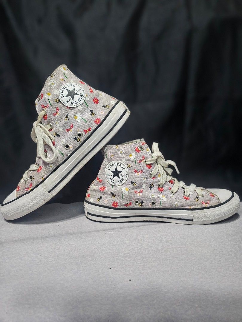 Converse All Star High Tops - Bee & Flower Print (Category: Sneakers) located in Lupao. Submitted by selahthriftedclothing (Listing ID 1463035574, Image 1). Description: - Cute Converse high tops - Fun bee and flower print - Light grey base with colorful details - Classic Chuck Taylor style - Laces included - Perfect for a playful touch to any outfit.