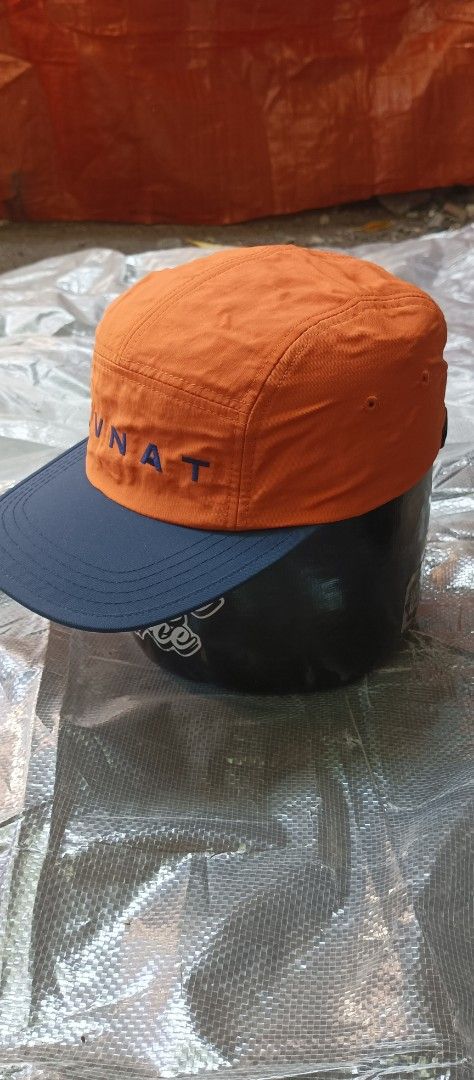 Covernat 5 Panel Cap Orange Navy (Category: Caps & Hats) located in Quezon City. Submitted by mangthrift (Listing ID 1463036794, Image 3). Description: - Brand: Covernat - Style: 5-panel cap - Color: Orange with navy blue brim - Features: 'CVNAT' embroidery on front - Fit: Adult one Size Adjustable strap at the back - Interior: Mesh lining and brand tags - Occasion: Great for casual wear.