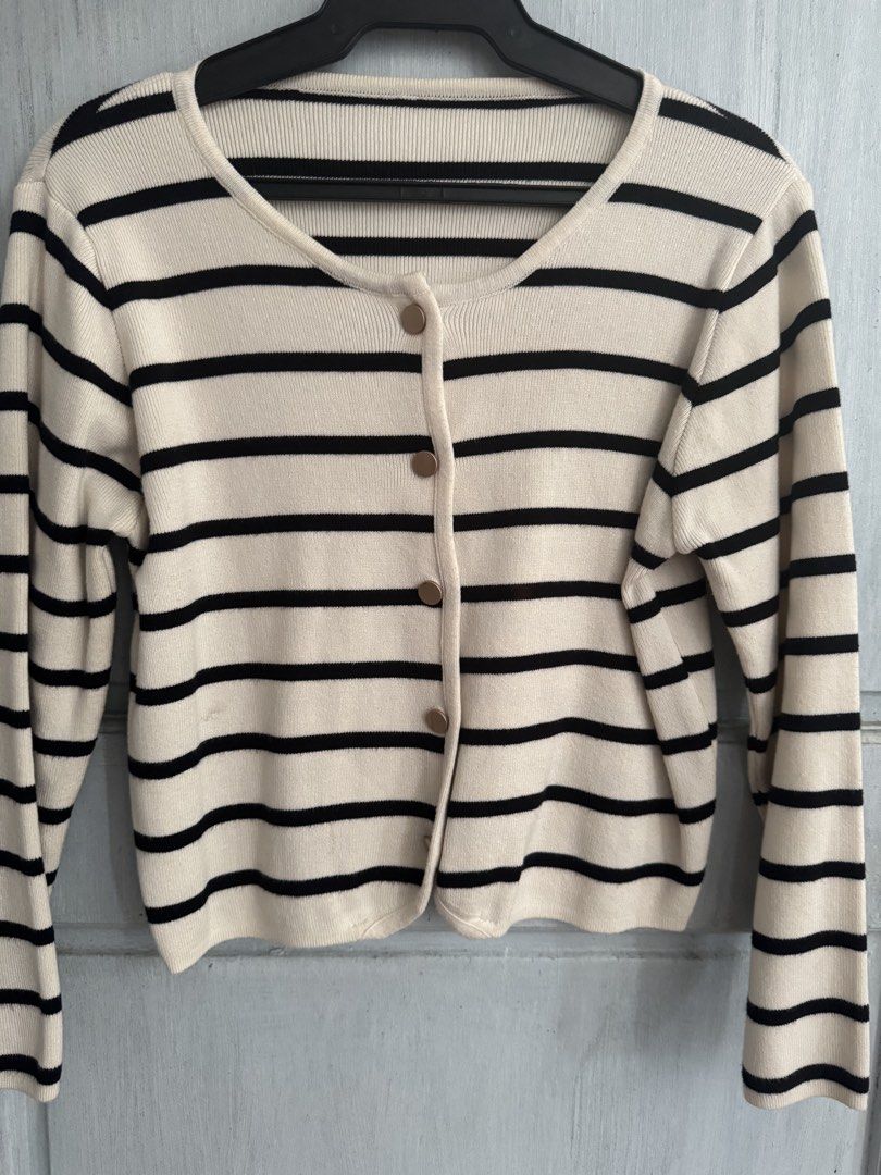 Cream and Black Striped Button-Up Cardigan (Category: Coats, Jackets and Outerwear) located in Manila. Submitted by decluterthings888 (Listing ID 1462950098, Image 1). Description: - Cream cardigan - Black horizontal stripes - Round neckline - Button-up front with gold-toned buttons - Long sleeves - Ideal for layering over tops or dresses - Versatile for casual or dressy occasions.