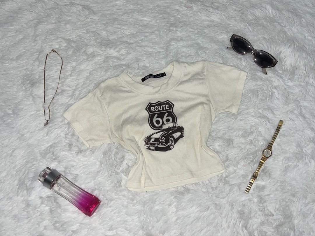 Cream Route 66 Graphic Crop Top (Category: Shirts) located in Tuguegarao City. Submitted by love_clothies (Listing ID 1462903839, Image 1). Description: - Cream colored crop top - Features a Route 66 graphic with a vintage car - Short sleeves and crew neck - Estimated size: Small to Medium (S/M) - Ideal for a casual, retro-inspired outfit - Pairs well with jeans or shorts.