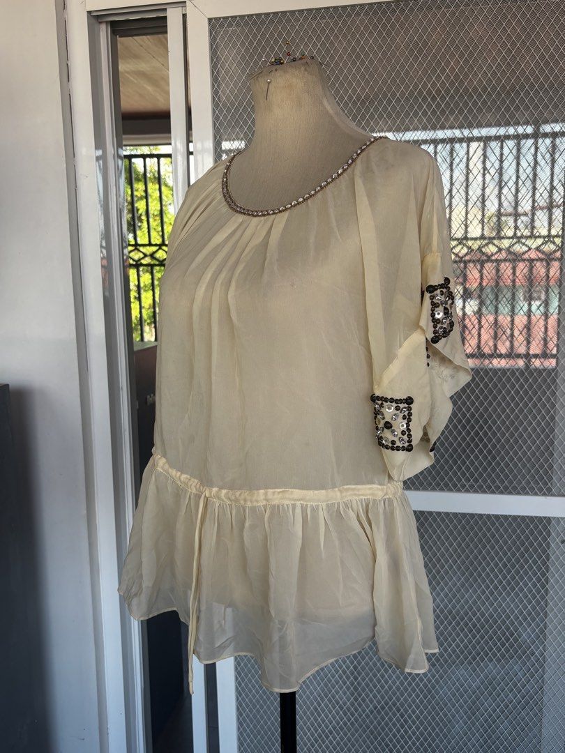 Cream Sheer Embellished Beaded Top (Category: Sleeveless) located in Apalit. Submitted by orchid555_ (Listing ID 1463004659, Image 1). Description: - Cream sheer top - Beaded embellishments on neckline and flutter sleeves - Gathered detail at neckline - Drawstring waist for adjustable fit - Lightweight and flowy fabric.
