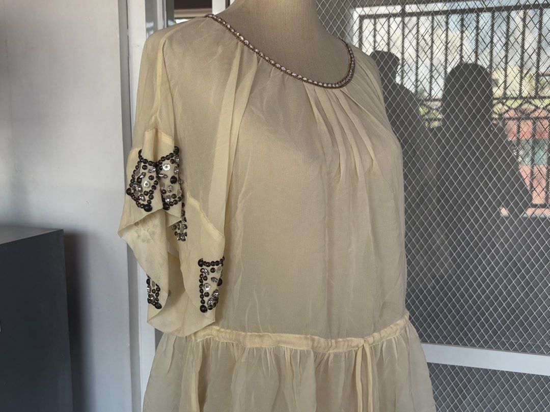 Cream Sheer Embellished Beaded Top (Category: Sleeveless) located in Apalit. Submitted by orchid555_ (Listing ID 1463004659, Image 2). Description: - Cream sheer top - Beaded embellishments on neckline and flutter sleeves - Gathered detail at neckline - Drawstring waist for adjustable fit - Lightweight and flowy fabric.