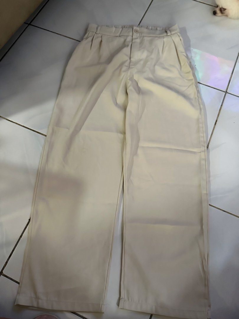 Cream Wide Leg Pleated Trousers (Category: Other Bottoms) located in Caloocan City. Submitted by triciacab (Listing ID 1462937146, Image 1). Description: - Cream colored wide leg pants - High-waisted design with front pleats - Secure button and zip closure - Convenient side pockets - Effortlessly transitions from casual to dressy - Easy to style for various occasions.