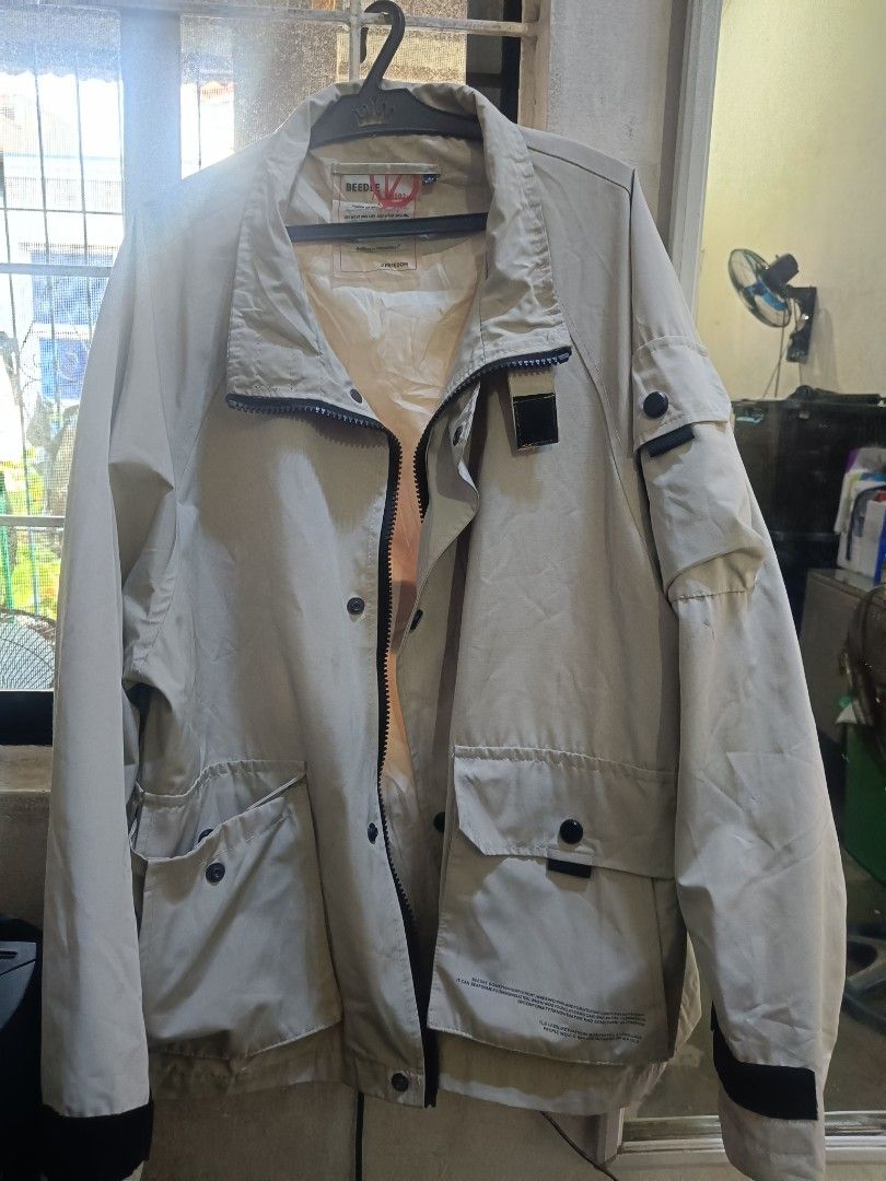 CREAM WINDBREAKER (Category: Coats, Jackets and Outerwear) located in Santa Rosa. Submitted by basmayorsh99139 (Listing ID 1463064259, Image 2). Description: - Cool beige jacket from BEEDY V-Line - Zip-up front with button closures - Multiple front pockets - Lined interior with an inner pocket - Unique design, great for layering - MEDIUM TO LARGE.