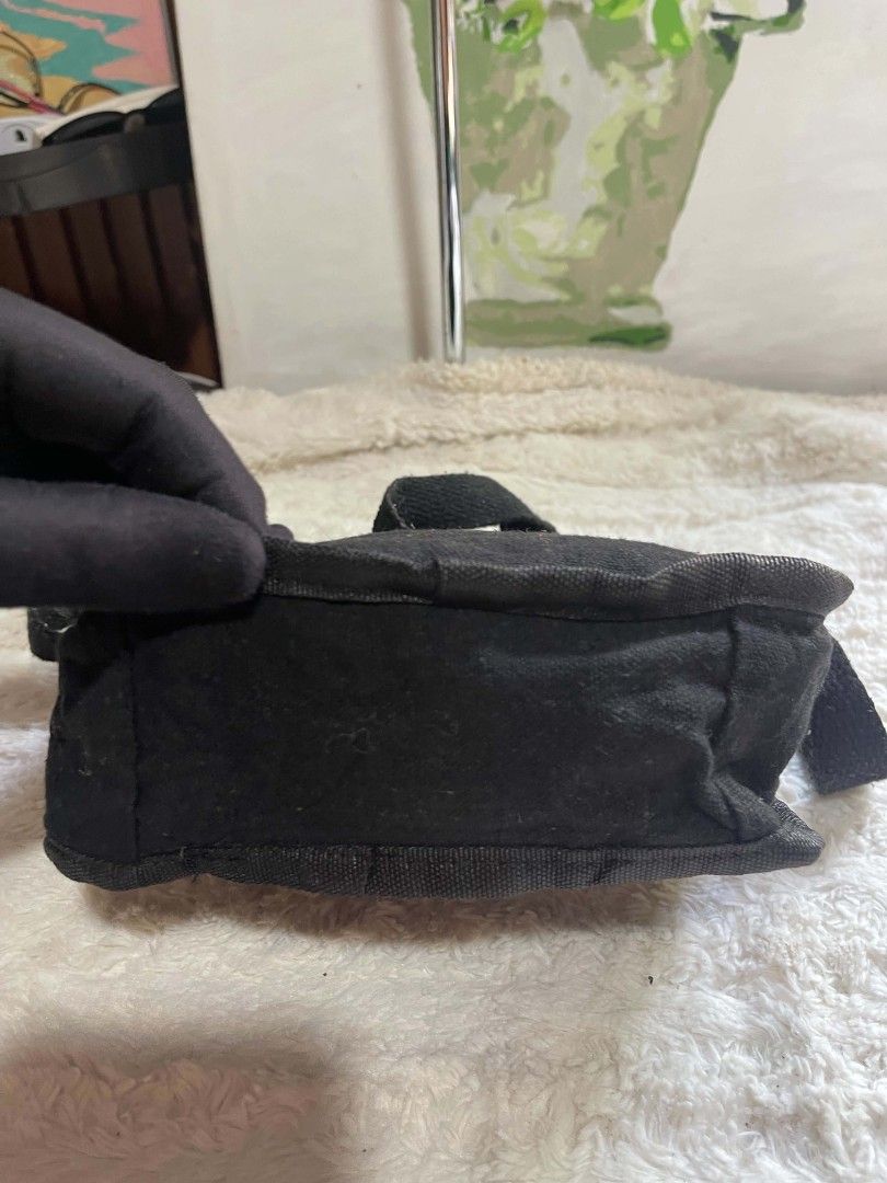 CUADRADO Black Canvas Crossbody Bag (Category: Sling Bags) located in Naawan. Submitted by twilly.apparel2 (Listing ID 1462959218, Image 3). Description: - Brand: CUADRADO - Color: Black - Type: Canvas Crossbody Bag - Features: Main compartment, front pocket, adjustable strap - Ideal for: Everyday use - Condition: Shows some signs of wear (lint on fabric), but fully functional and ready for a new owner..