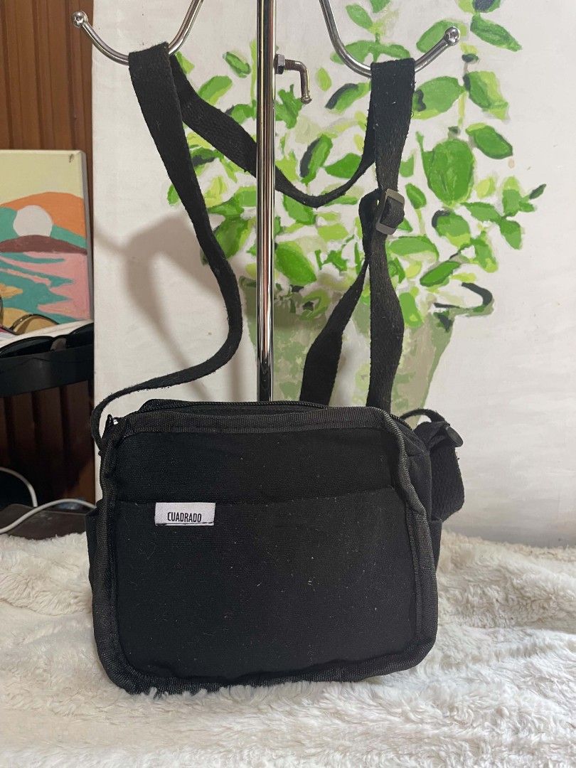CUADRADO Black Canvas Crossbody Bag (Category: Sling Bags) located in Naawan. Submitted by twilly.apparel2 (Listing ID 1462959218, Image 1). Description: - Brand: CUADRADO - Color: Black - Type: Canvas Crossbody Bag - Features: Main compartment, front pocket, adjustable strap - Ideal for: Everyday use - Condition: Shows some signs of wear (lint on fabric), but fully functional and ready for a new owner..