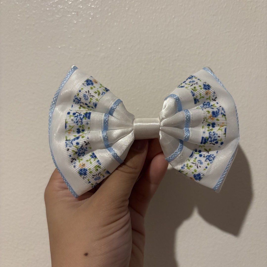 Cute Hair Clips & Bows Set - Various Designs (Category: Hair Accessories) located in Manila. Submitted by robbyrabbit (Listing ID 1462922509, Image 3). Description: - Set of cute hair accessories perfect for kids or anyone who loves adorable styles. - Includes floral bows with red, grey, and blue trim. - Features two pink cloud-shaped snap clips with My Melody. - Comes with two dusty rose flower clips and a matching bow..