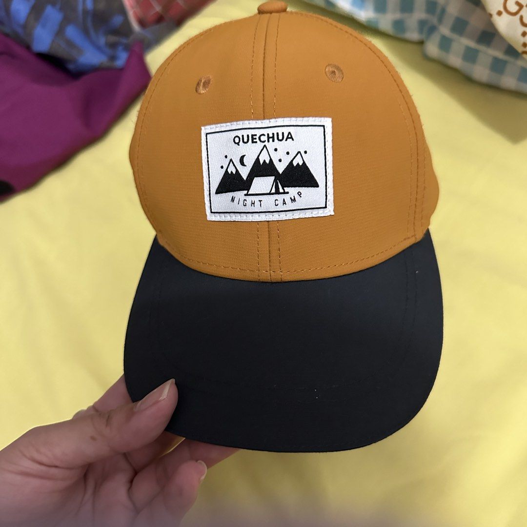 Decathlon Quechua Cap (Category: Caps & Hats) located in Kawit. Submitted by wevibevintage (Listing ID 1463043318, Image 2). Description: - Orange cap with a classic black brim. - Features a 'Quechua Night Camp' embroidered patch on the front. - Ideal for outdoor activities like camping and hiking. - Also great for casual, everyday wear. - Provides sun protection on bright days. - Simple, stylish, and versatile design..