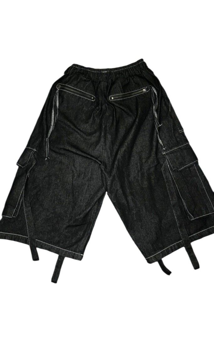 Denim Cargo Shorts with Straps (Category: Shorts) located in Maasim. Submitted by ukayganda25 (Listing ID 1463051582, Image 2). Description: - Black denim shorts - White stitching detail - Elastic waistband with drawstring - Multiple cargo pockets (front and back) - Adjustable straps on pockets - Wide leg, loose fit - Ideal for streetwear style -26-36 W 28.5 L 13.5 LO.