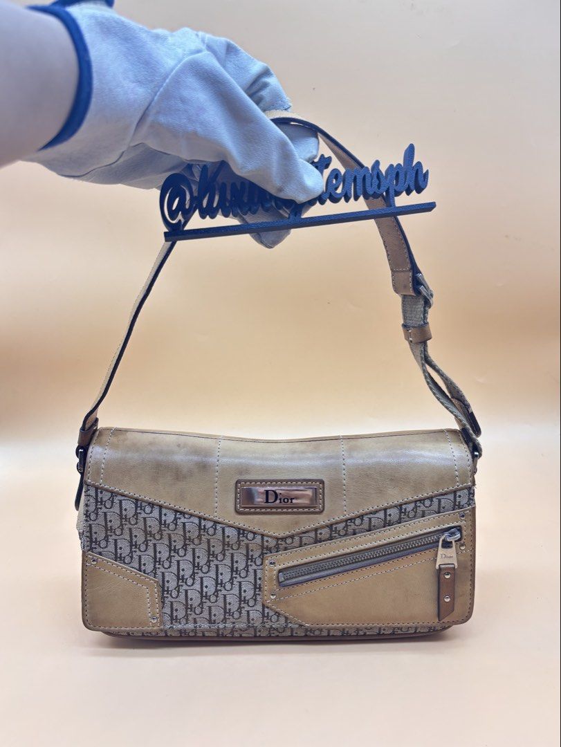 Dior Street Chic Monogram Shoulder Bag (Category: Luxury Bags & Wallets) located in Pamplona. Submitted by luxuryitems_ph (Listing ID 1462991762, Image 1). Description: - Authentic Dior shoulder bag - Classic Dior monogram pattern - Tan leather accents - Front zipper pocket - Adjustable strap - Perfect for everyday style - Shows some signs of wear on the leather.