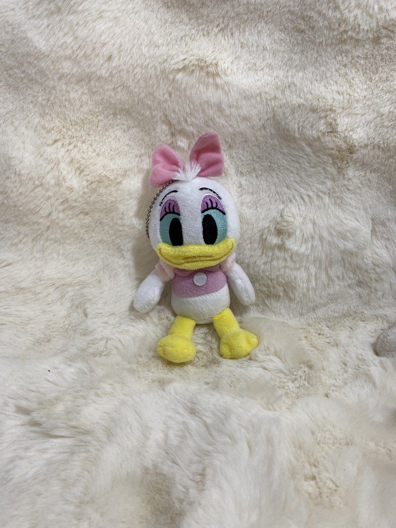 Disney Daisy Duck Plush charm (Category: Plushies & Soft Toys) located in Kalibo. Submitted by ollie_stuffshop (Listing ID 1462897540, Image 1). Description: Before you send your inquiries: ❗️Last Price is already posted ❗️Manage your expectations, WYSIWYG ❗️May need washing ❗️Dropoff is every Wednesday & Sunday - Adorable Daisy Duck plush toy - Features a cute pink bow and pink top - Classic yellow feet and beak - Includes a metal keychain loop 