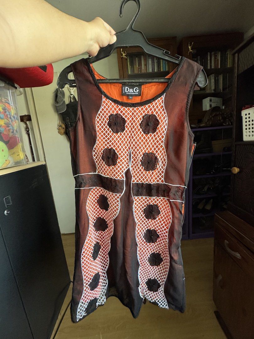 Dolce & Gabbana Floral Orange Dress (Category: Dresses) located in Mabalacat. Submitted by darkmochafrappe2 (Listing ID 1462906836, Image 1). Description: - Dolce & Gabbana dress - Vibrant orange silk material - Unique mesh and floral applique details - Stylish lace-up back - Size 4 - Perfect statement piece for any occasion.
