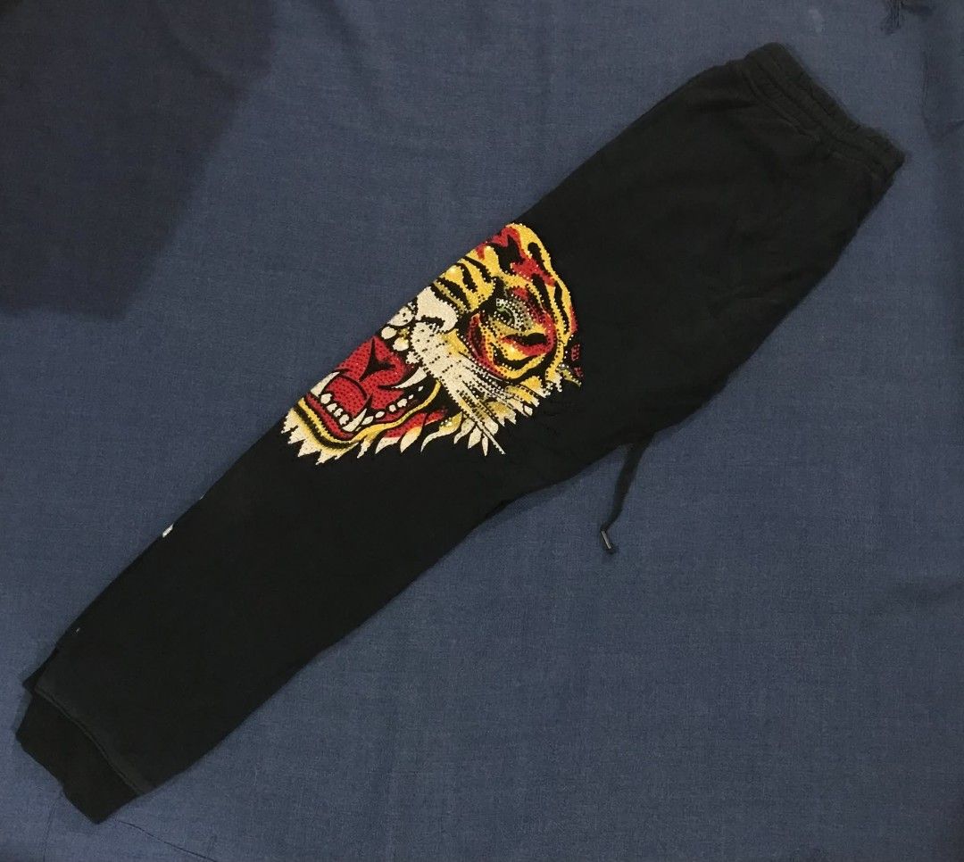 Ed Hardy Black Tiger & Logo Sweatpants (Category: Joggers) located in Manila. Submitted by its_d4ve (Listing ID 1463041642, Image 3). Description: - Black sweatpants - Large embroidered tiger graphic on the left leg - Ed Hardy Designs logo embroidered on the back pocket and down the right leg - Drawstring waist - Comfortable and stylish.