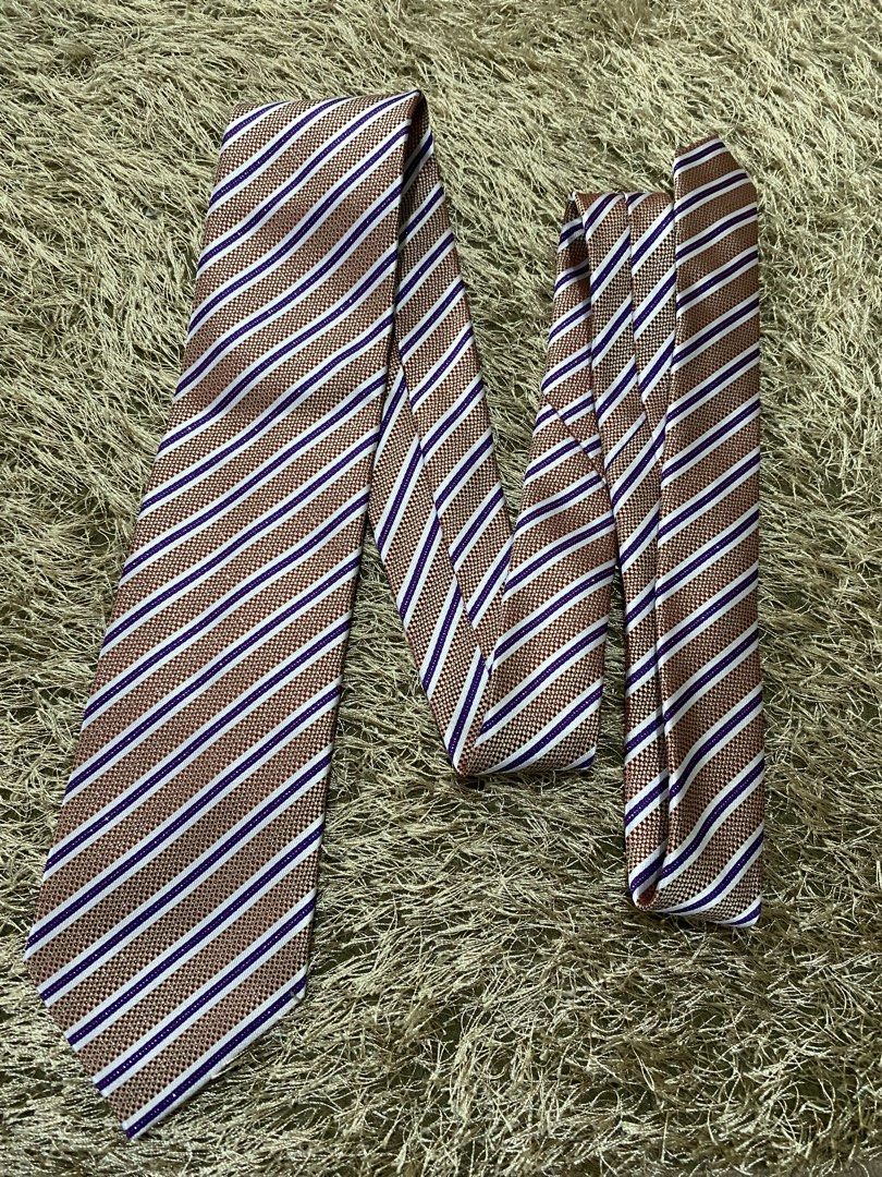 Elegance Striped Tie - Brown, White, Purple (Category: Ties) located in Bulacan. Submitted by rich2545 (Listing ID 1462905334, Image 1). Description: - Classic striped tie from Elegance - Features brown, white, and purple stripes - Subtle textured weave fabric - Ideal for formal or business casual occasions - A stylish accessory to elevate your look.