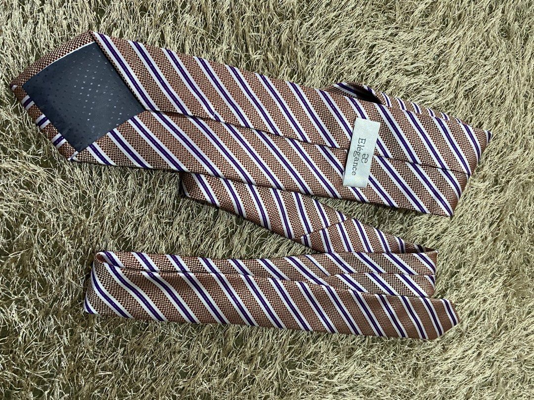 Elegance Striped Tie - Brown, White, Purple (Category: Ties) located in Bulacan. Submitted by rich2545 (Listing ID 1462905334, Image 3). Description: - Classic striped tie from Elegance - Features brown, white, and purple stripes - Subtle textured weave fabric - Ideal for formal or business casual occasions - A stylish accessory to elevate your look.