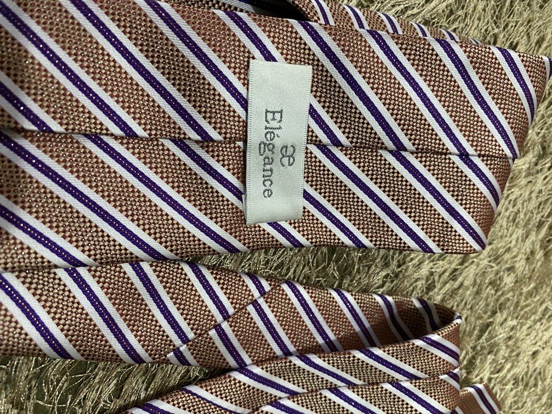 Elegance Striped Tie - Brown, White, Purple (Category: Ties) located in Bulacan. Submitted by rich2545 (Listing ID 1462905334, Image 2). Description: - Classic striped tie from Elegance - Features brown, white, and purple stripes - Subtle textured weave fabric - Ideal for formal or business casual occasions - A stylish accessory to elevate your look.