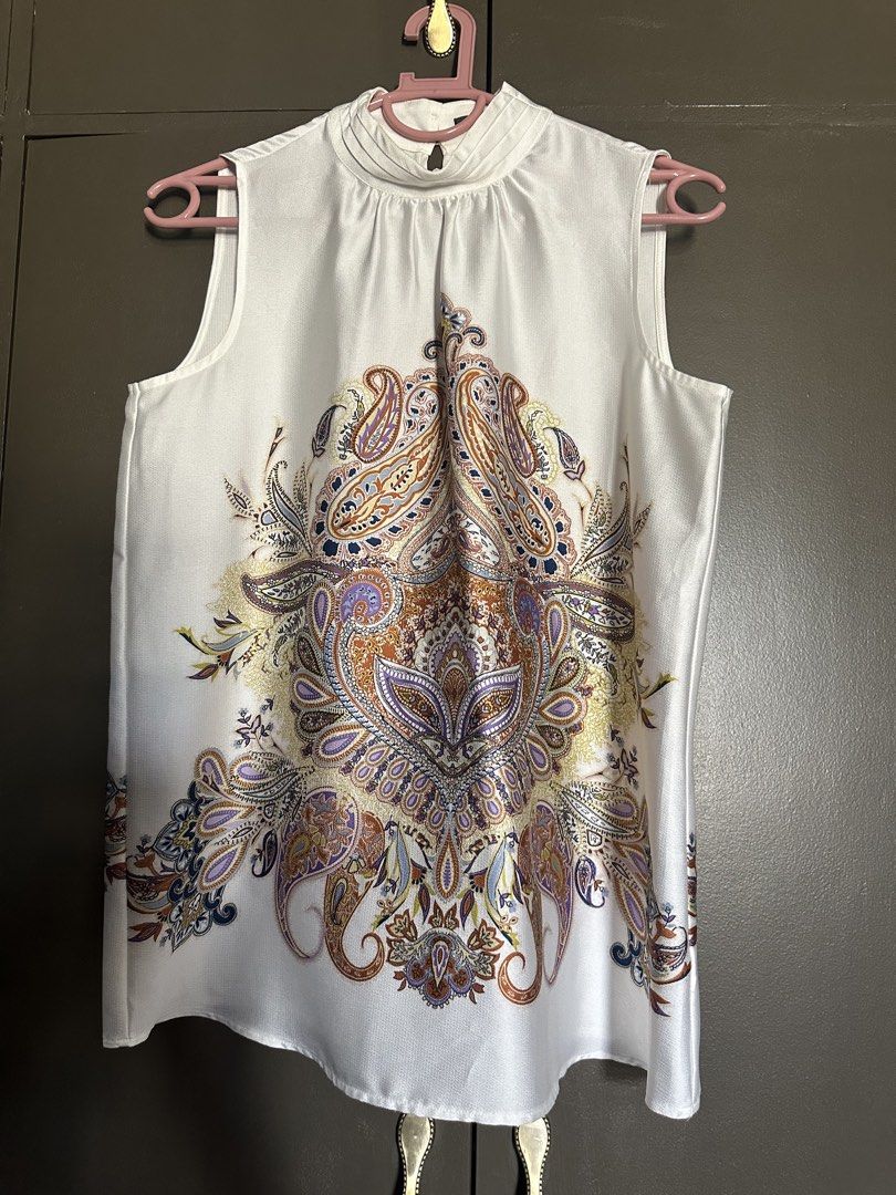 Esprit White Sleeveless Top with Paisley Print (Category: Sleeveless) located in Makati City. Submitted by i_am_spring87 (Listing ID 1462911087, Image 1). Description: - White sleeveless top - Intricate paisley print - Elegant high neckline with subtle gathering - Convenient button closure at the back - Perfect for dressing up or down - Approximate measurements: 20 inches length, 19 inches chest width.