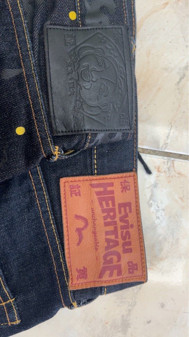 Evisu Heritage Jeans - Size 32 & 36 (Category: Jeans) located in Cotabato. Submitted by zhypedends136 (Listing ID 1462921218, Image 3). Description: - Authentic Evisu Jeans, Size 32 (2 pairs available) - Material: 100% Cotton - Pair 1: Dark wash with iconic blue seagull logo and Japanese text on back pockets. - Pair 2: Dark wash with a subtle camouflage pattern and yellow dot details. - Perfect for denim enthusiasts looking for unique designs. Ch