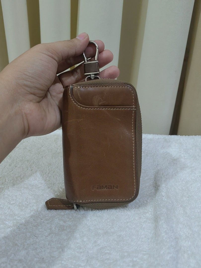 Faman Leather Zippered Key Holder Pouch (Category: Wallets & Card holders) located in Makati City. Submitted by prelovedtreatedwithlove (Listing ID 1463027439, Image 3). Description: - Genuine Faman brown leather key holder - Secure zipper closure - Interior with 6 key hooks - Convenient small front pocket - Perfect for organizing your keys - Just scratches A-182.