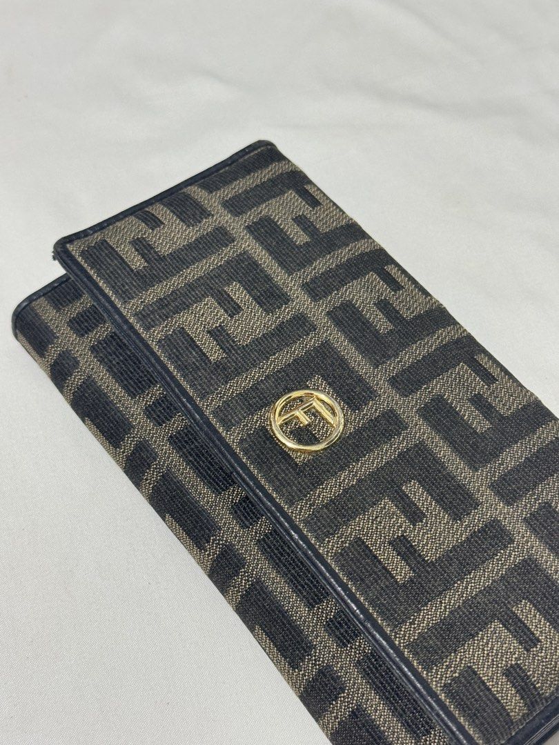 Fendi Zucca Canvas Continental Long Wallet (Category: Luxury Bags & Wallets) located in Manila. Submitted by rzkei (Listing ID 1462943870, Image 3). Description: - Authentic Fendi wallet - Classic Zucca canvas pattern - Black leather interior - Zippered coin pocket - Multiple card slots and bill compartments - Gold tone Fendi logo hardware - Secure snap closure 📍Taguig Price is negotiable..