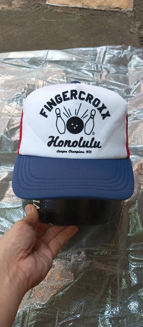 Fingercroxx Trucker Hat SnapBack (Category: Caps & Hats) located in Quezon City. Submitted by mangthrift (Listing ID 1463041476, Image 1). Description: - Brand: Fingercroxx - Design: Honolulu League Champions 1975 - Trucker Hat snap back - Colorway: White front panel, red mesh back, blue brim and front detail - Features: Adjustable snapback closure - Style: Ideal for casual wear - Excellent condition .