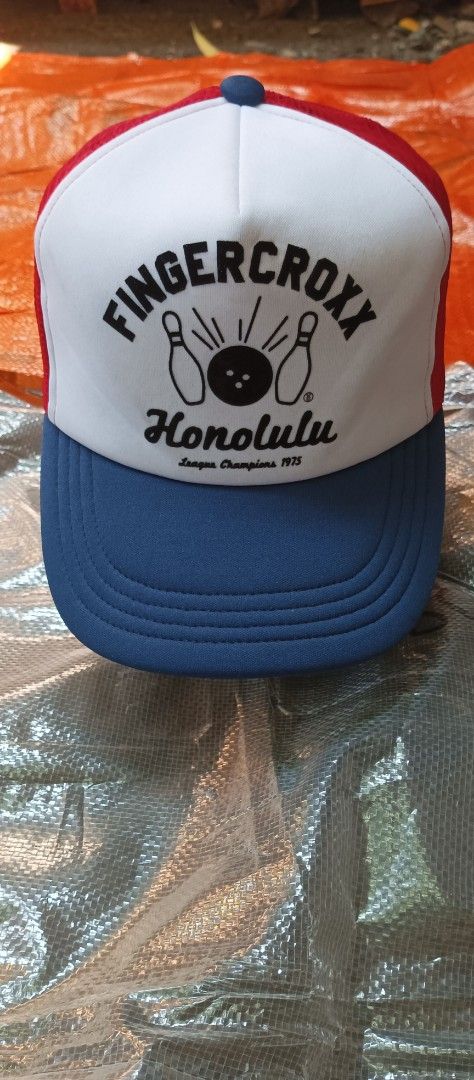 Fingercroxx Trucker Hat SnapBack (Category: Caps & Hats) located in Quezon City. Submitted by mangthrift (Listing ID 1463041476, Image 2). Description: - Brand: Fingercroxx - Design: Honolulu League Champions 1975 - Trucker Hat snap back - Colorway: White front panel, red mesh back, blue brim and front detail - Features: Adjustable snapback closure - Style: Ideal for casual wear - Excellent condition .