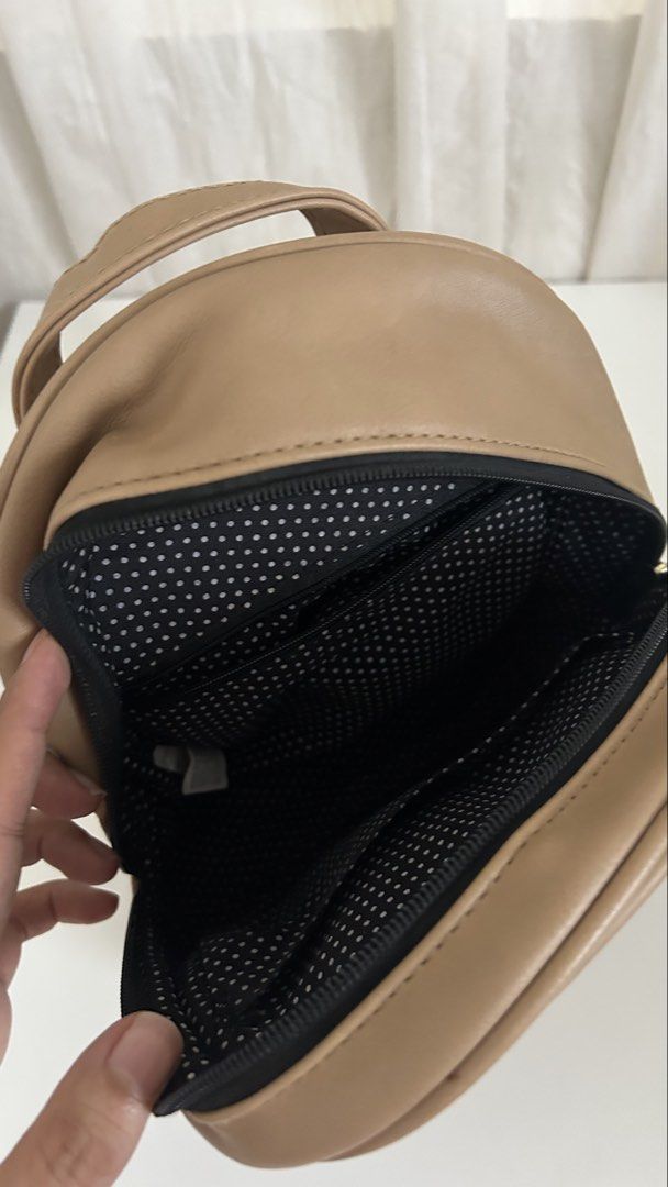 Fioni Leather Bag (Payless) (Category: Backpacks) located in Cavite. Submitted by yamyam. (Listing ID 1462914780, Image 2). Description: - Cute tan mini backpack - Black and silver star appliques on the front - Polka dot lining inside the main compartment - Zipper closure - Small top handle and adjustable shoulder straps - Ideal for everyday use or travel.